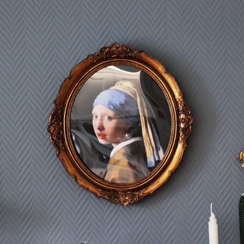 Round vintage-style mirror with an ornate gold frame featuring 'Girl with a Pearl Earring' artwork. A unique decorative piece for classic interiors.