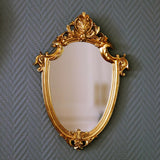 Classic gold vintage-style decorative mirror with ornate resin frame. Perfect for European-inspired interiors, adding elegance and practicality.