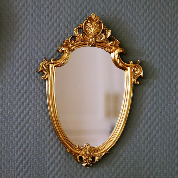 Classic gold vintage-style decorative mirror with ornate resin frame. Perfect for European-inspired interiors, adding elegance and practicality.